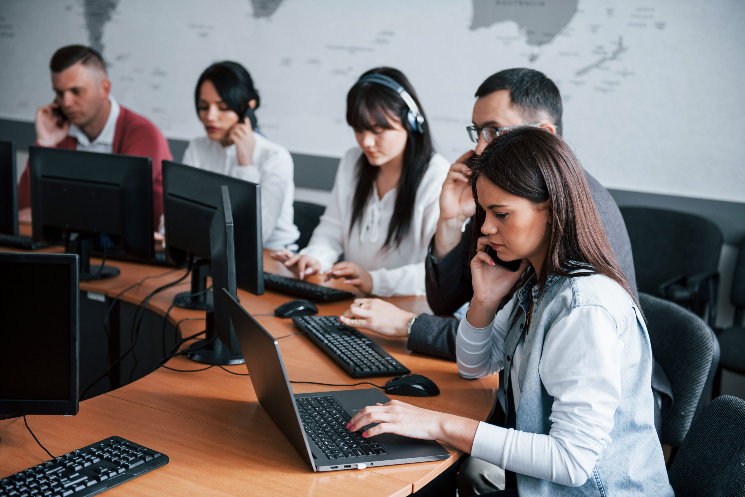 Noisy room. Young people working in the call center. New deals is coming.