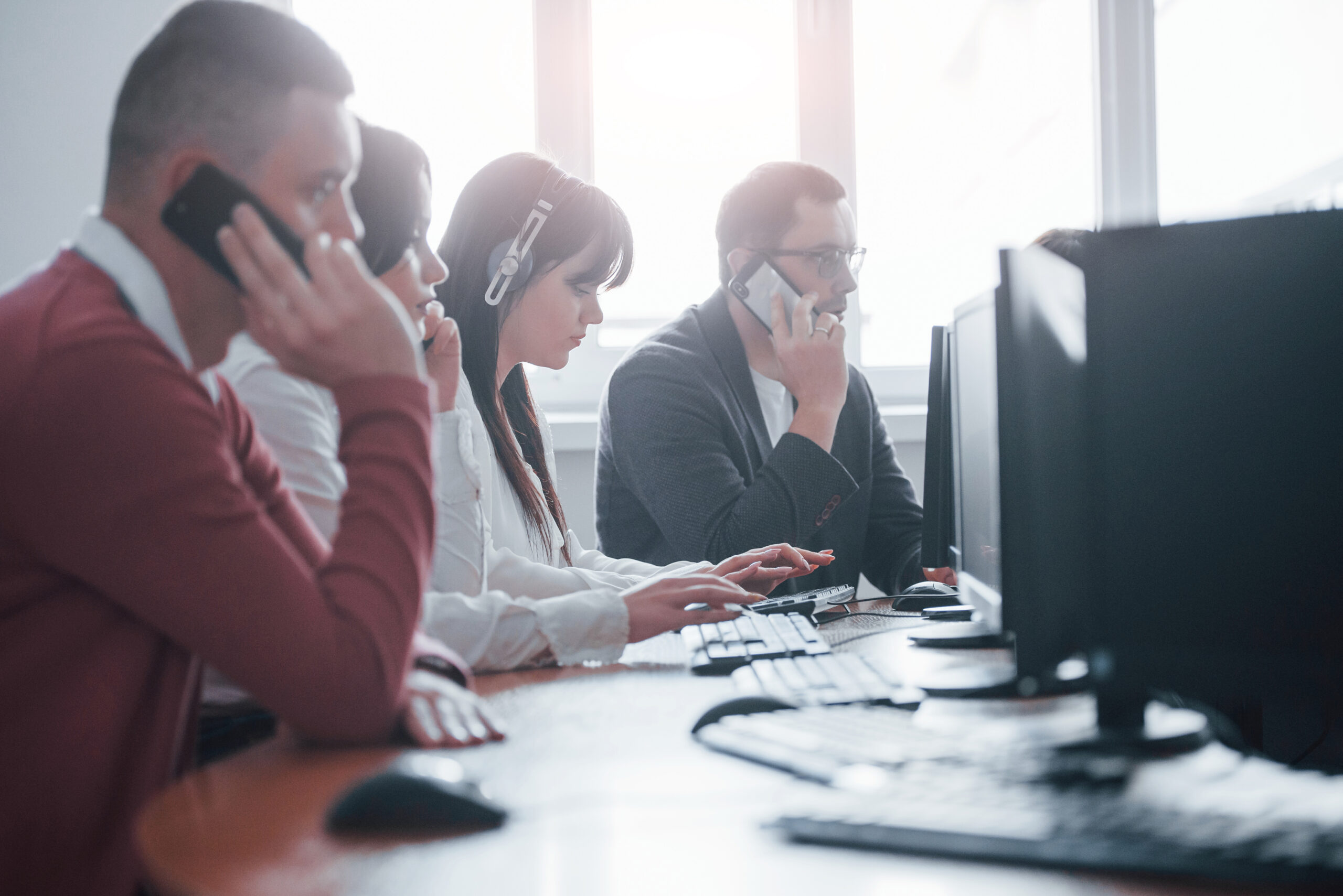 Nice weather outside. Young people working in the call center. New deals is coming.